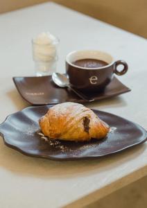 a plate with a pastry and a cup of coffee at Gocce su Pietra in Sannicandro di Bari