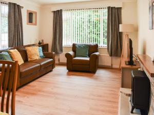 a living room with a couch and a chair at Gwynfa in Rhyl