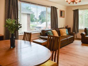 a living room with a table and a couch at Gwynfa in Rhyl