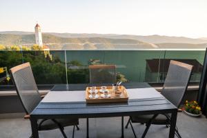 a table with a tray of candles on a balcony at Casa sul Mare Luxury Sea View Apartments in Neum