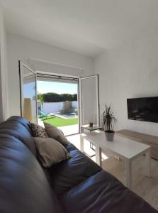 a living room with a blue couch and a table at Casa Martina in Cádiz
