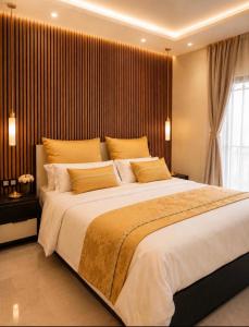 a bedroom with a large bed with a large window at Massa Residence Meublé Yaounde in Yaoundé