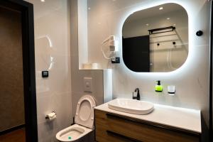 a bathroom with a sink and a toilet and a mirror at Casa sul Mare Luxury Sea View Apartments in Neum +66 photos