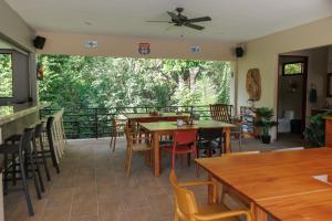 a restaurant with tables and chairs on a balcony at Hotel Las Lomas in Nandayure