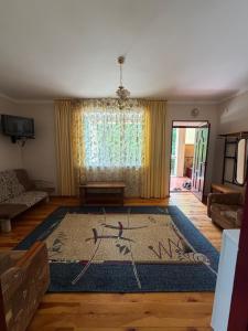 a living room with a rug on the floor at Алтын Мезгил in Korumdy