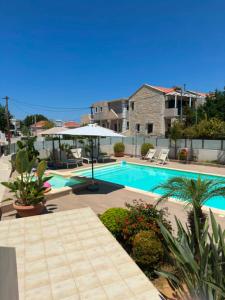 a swimming pool in a yard with at Four Seasons Homes in Stalos