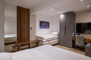a hotel room with a bed and a desk and a tv at Casa sul Mare Luxury Sea View Apartments in Neum