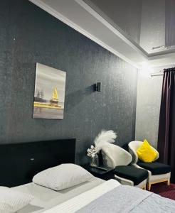 a bedroom with a bed and a sailboat on the wall at Oral City Hotel in Oral
