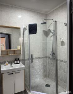 a bathroom with a shower and a sink at Oral City Hotel in Oral