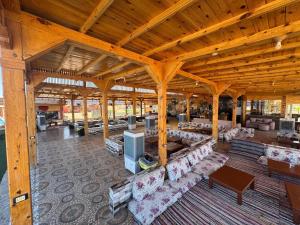 a large pavilion with couches and a television in it at Sondos Camp in Nuweiba‘ el Muzeinah