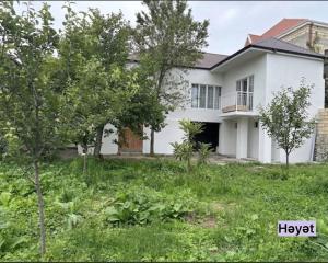 a white house with trees in the yard at Sheki Center Home in Sheki
