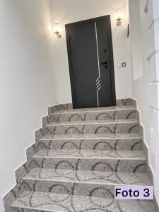a set of stairs with a door in the middle at Sheki Center Home in Sheki +1 photo