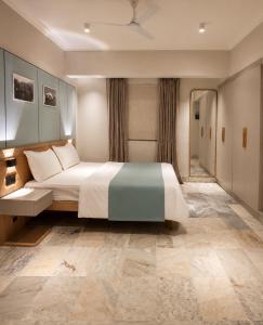 a bedroom with a large bed in a room at MG Villa - A Boutique Stay in Navi Mumbai
