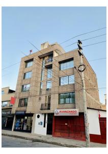 a building on the corner of a street at Apartamentos WANCA SUITES para 4, 5 y 6 huéspedes cochera muy cerca al Centro in Huancayo
