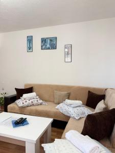 a living room with a couch and a table at JEA House in Pogradec