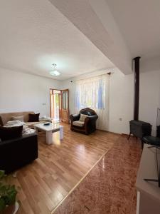 a living room with a couch and a table at JEA House in Pogradec