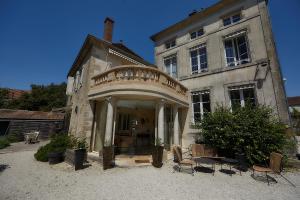 an old building with chairs in front of it at Manoir de L'Echauguette in Laignes