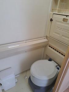 a small bathroom with a white toilet in it at Private caravan with mountain and sea view in Guájar-Faragüit