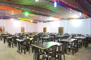 a large room with tables and chairs in it at Musafir Desert Camp Jaisalmer in Jaisalmer