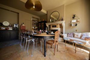 a living room with a table and a couch at Manoir de L'Echauguette in Laignes
