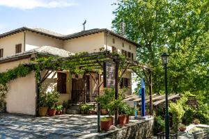 a building with a pergola in front of it at KissosInn in Kissos