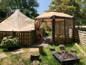 a gazebo with a tent in a yard at Badgers Burrow in Colwall