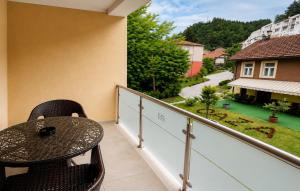 a patio with a table and chairs on a balcony at Hotel Oaza in Konjic +10 photos