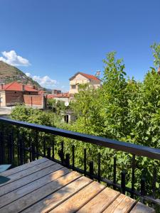 a wooden bench sitting on top of a balcony at JEA House in Pogradec