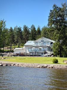 a large house on the shore of a river at Radalla Resort in Kausala