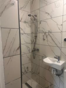 a bathroom with a shower and a sink at Peace Guest House in Hoo +10 photos