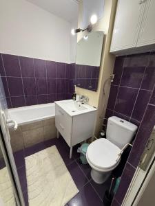 a bathroom with a toilet and a sink and a mirror at Home Studio Arad in Arad