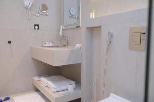 a white bathroom with a sink and a shower at شاليهات واجهة الشفا in Taif +69 photos