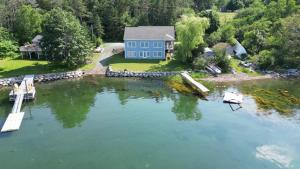 an aerial view of a blue house on the water at On Da Water in Lunenburg