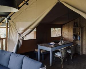 a dining room with a table in a tent at Agriturismo Angeli Sognanti in Cossignano