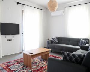 a living room with a couch and a coffee table at Petra Evleri in Örencik