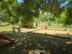 a child playing in a sandbox in a park at Apartmány Baťovany in Partizánske
