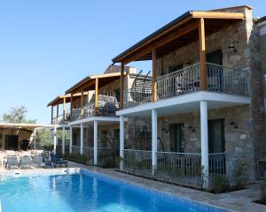 a house with a swimming pool in front of it at Petra Evleri in Örencik