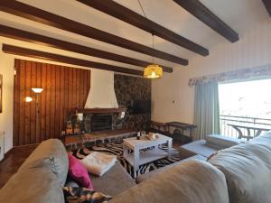a living room with a couch and a fireplace at Villa Serra Brava mt Gemeinschatspool, 3 Apartments in Lloret de Mar