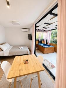 a room with a table and a bed and a bedroom at Grand Relax Suites in Diakopto +94 photos