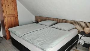 a bed with two pillows on it in a bedroom at Bergblick2 in Zell an der Mosel