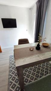 a living room with a wooden table and a chair at Bergblick2 in Zell an der Mosel
