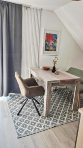 a wooden table and a chair in a room at Bergblick2 in Zell an der Mosel