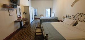 a bedroom with a bed and a desk and a bed at Sulla via Francigena in Fucecchio