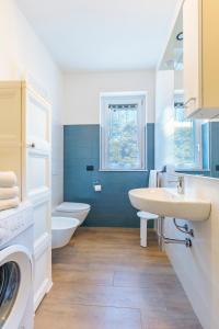 a bathroom with two sinks and a washing machine at Appartamenti BluMare in Diano Marina +73 photos