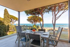 a dining room with a table with a view of the ocean at Appartamenti BluMare in Diano Marina