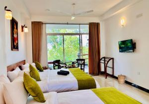 a hotel room with two beds and a large window at Ella Pine Crest in Ella