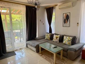 a living room with a couch and a table at The Lemon Villa in Rogachevo