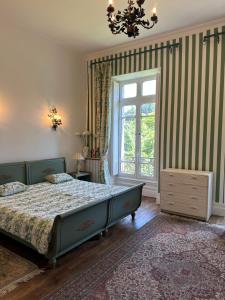 a bedroom with a bed and a window at Château Mesdames in Labastide-Rouairoux