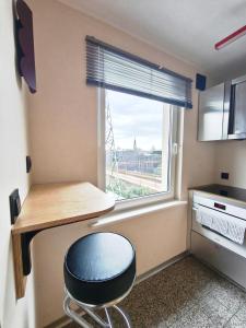 a room with a desk and a chair in front of a window at Loft Hause Sopot in Sopot