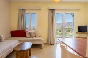 a living room with a couch and a table at Cavo Plako Villas in Palekastron